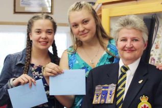 Patty Middleton presented bursary cheques to GREC students Corrie-Lyn Shields and Destanie Lalonde in a special ceremony at the Sharbot Lake Legion Friday night. Photo/Craig Bakay